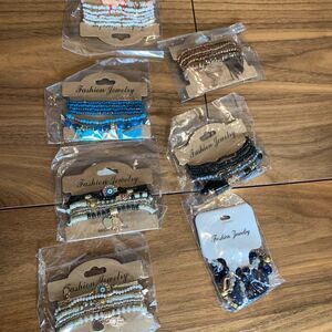 New, bundle of 3 packs of 6 strands each, beads and charms on stretch chord